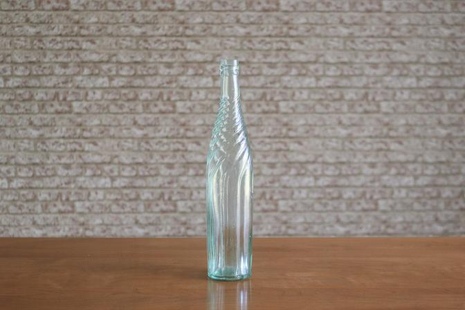 Vintage Green Glass Embossed Bottle